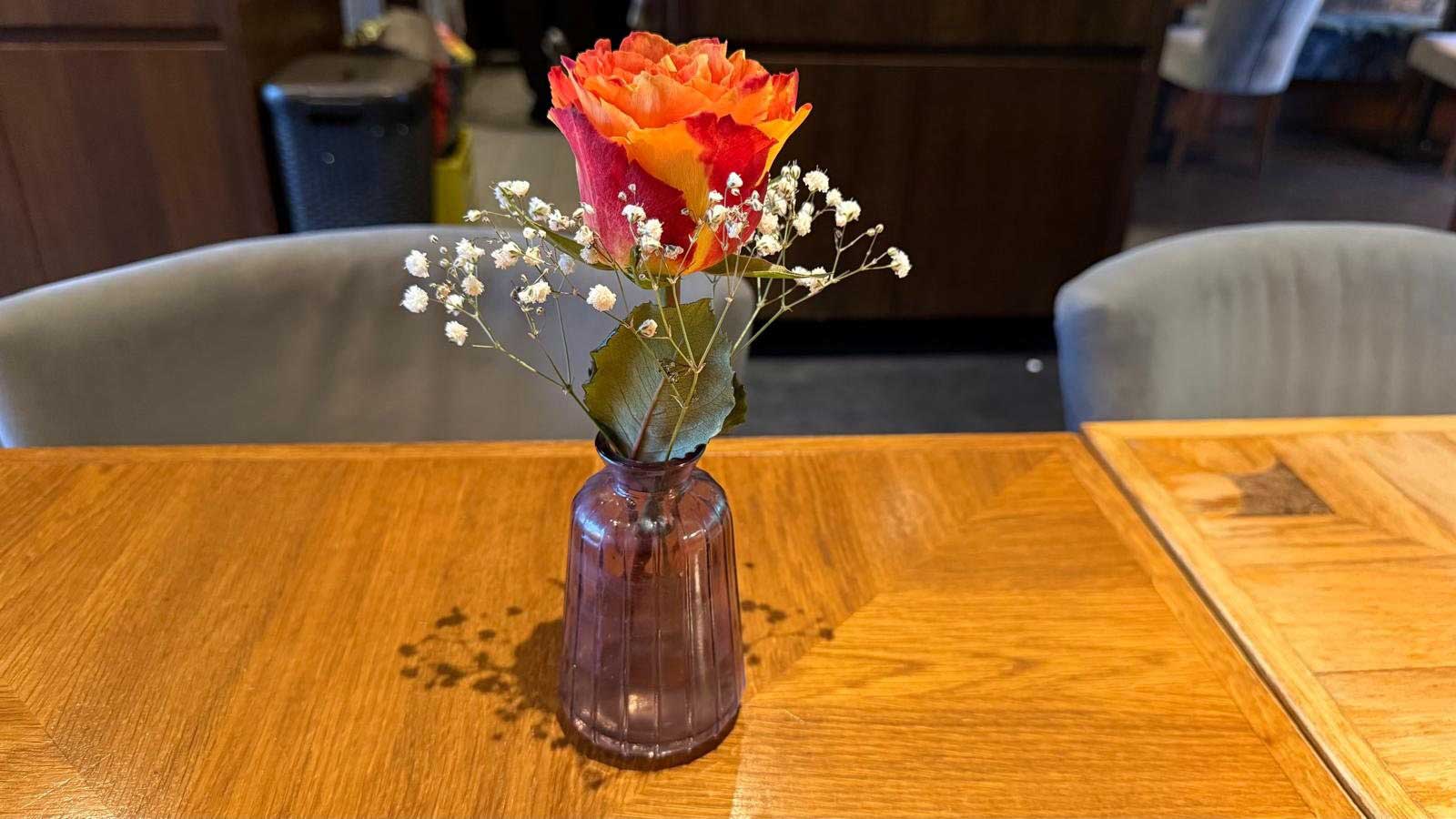 Blume auf einem Holztisch im VietRoyal Baldham mit ruhiger Restaurantstimmung